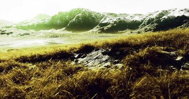Green hills and rugged mountains bask in bright, serene sunlight video