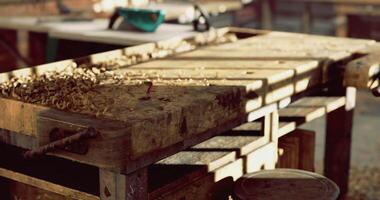 Woodworking bench with shavings in a bright workshop surrounded by tools video