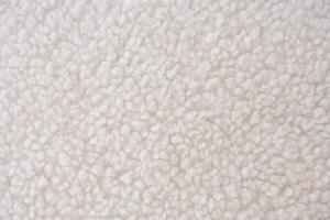 Detailed close-up of plush white sherpa fleece fabric with a wavy, curly pattern photo