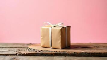 Kraft paper gift box tied with ribbon soft pink background photo