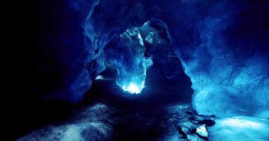 Exploration of a stunning blue ice cave illuminated by natural light video