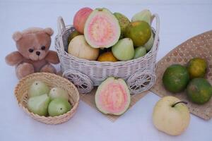 A Basket of Fresh Tropical Fruits and Teddy Bear photo