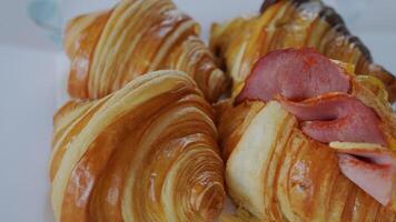 Rotating Footage of Various croissants including Plain and Ham and Cheese video