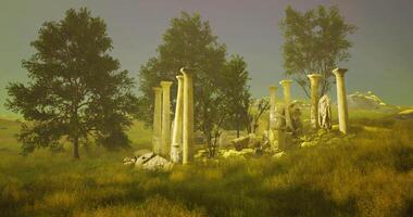 Ruins of ancient columns surrounded by trees in a serene landscape video