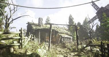 Old rustic cabin and windmill surrounded by trees in a rural setting video