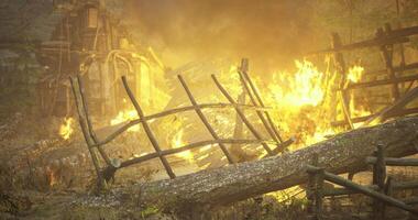 Destruction of a wooden structure by fire in a forest setting at dusk video
