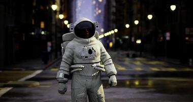 Astronaut exploring an empty urban street at twilight under soft streetlights video