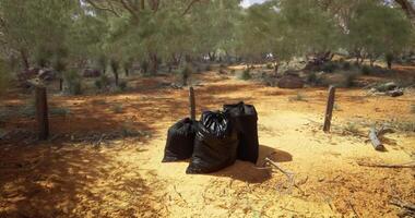 Trash bags left in a deserted area of the Australian outback video