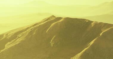 Sunset over golden mountain landscape in serene natural setting video