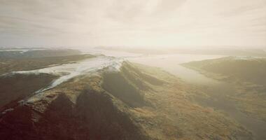 Mountain landscape with river and clouds under bright sky in daylight video