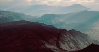 Misty mountain landscape with layered hills and soft light at dusk video