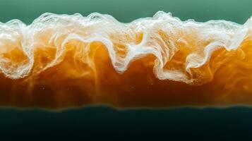 Close-up view of frothy beverage with swirling patterns against a blurred background photo