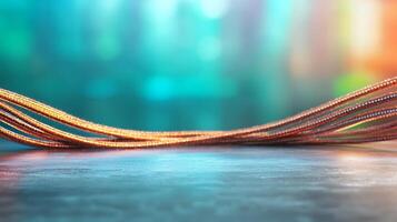 Close-up view of intertwined copper wires on a smooth surface with a colorful blurred background photo