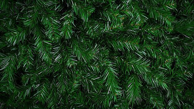 Close-up view of lush green artificial pine branches creating a textured background photo