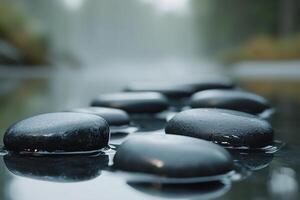 Smooth black stones balance gracefully over a misty water surface, reflecting the serene environment that promotes meditation, calmness, and deep focus photo