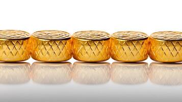 Close-up view of shiny gold decorative elements arranged in a line on a reflective surface photo