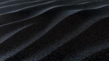 Close-up view of shimmering black sand dunes under soft light, showcasing intricate patterns and textures photo