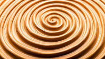 Close-up view of smooth, swirled creamy texture resembling peanut butter on a surface photo