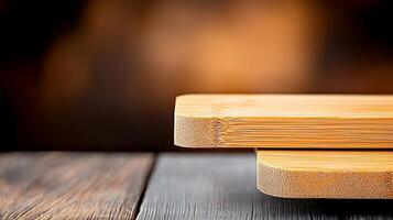 Close-up view of smooth wooden cutting boards stacked on a rustic table with a blurred background photo