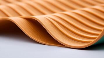 Close-up view of textured orange material with wavy patterns, showcasing its smooth surface and flexibility photo