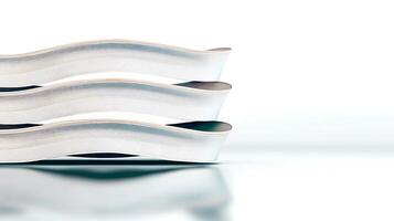 Close-up view of three stacked, curved white objects on a smooth surface with soft lighting photo