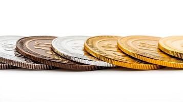 Close-up view of various coins arranged in a line, showcasing different colors and textures photo