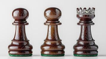Close-up view of three wooden chess pieces representing pawn and queen on a neutral background photo