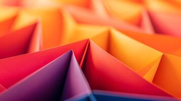 Close-up view of vibrant, folded paper patterns showcasing a gradient of colors, ideal for design photo