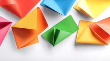 Colorful assortment of folded paper envelopes and shapes arranged on a clean surface photo