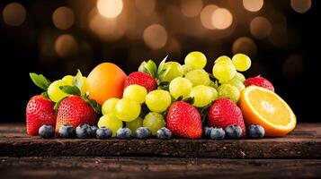 Colorful assortment of fresh fruits including strawberries, grapes, oranges, and blueberries on a wooden table with a blurred bokeh background photo