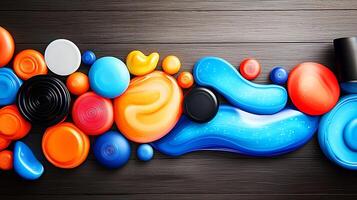 Colorful assortment of paint blobs arranged artistically on a wooden surface, showcasing creativity photo