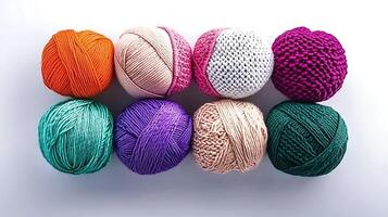 Colorful assortment of yarn balls arranged in a grid, showcasing various textures and hues photo