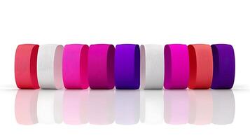 Colorful collection of rubber bands arranged in a row on a reflective surface photo