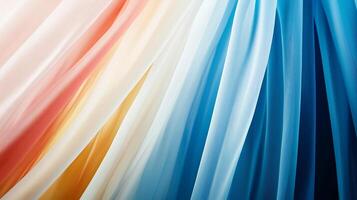 Colorful flowing fabric drapes in soft hues of orange, cream, blue, and teal, creating a serene backdrop photo
