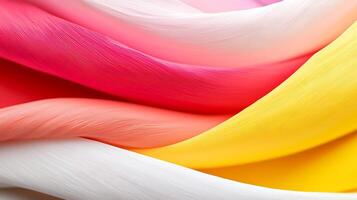 Colorful flowing fabric textures in vibrant pink, yellow, and white, creating a dynamic visual effect photo