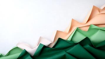 Colorful folded paper creating a textured wave effect on a clean white background photo