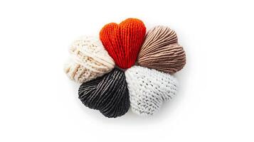Colorful knitted heart-shaped yarn balls arranged in a circular pattern on a white background photo