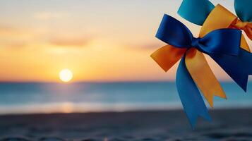 Colorful ribbons in blue and yellow adorn a beach at sunset, creating a festive atmosphere photo