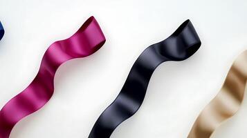 Colorful satin ribbons in varying shades elegantly arranged on a light background, ideal for design photo