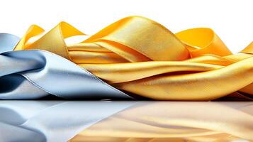 Colorful silk ribbons in blue and gold intertwined on a reflective surface, creating an elegant display photo
