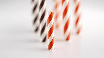 Colorful striped paper straws arranged artistically on a clean white background for beverage use photo