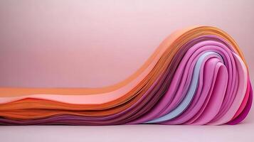Colorful wave of layered paper sheets in shades of pink and orange, creating a smooth gradient effect photo