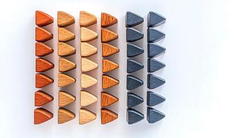 Colorful wooden triangular blocks arranged in rows, showcasing various shades and textures photo