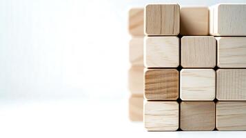 Stacked wooden blocks arranged in a neat formation on a clean white surface with soft lighting photo