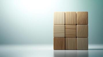 Stacked wooden blocks arranged in a cube formation against a soft gradient background photo
