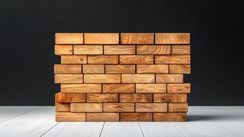 Stacked wooden blocks arranged neatly on a white surface against a dark backdrop photo