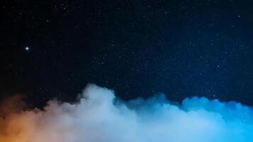 Starry night sky with clouds illuminated by orange and blue hues, creating a serene atmosphere photo