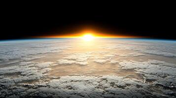 Sunrise over Earths horizon with clouds illuminated by golden light, serene atmosphere photo