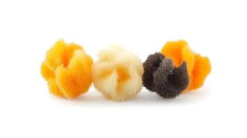 Three colorful cleaning sponges arranged artistically on a white background, showcasing texture and design photo