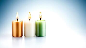 Three lit candles in warm and cool colors against a soft gradient background, creating a serene ambiance photo